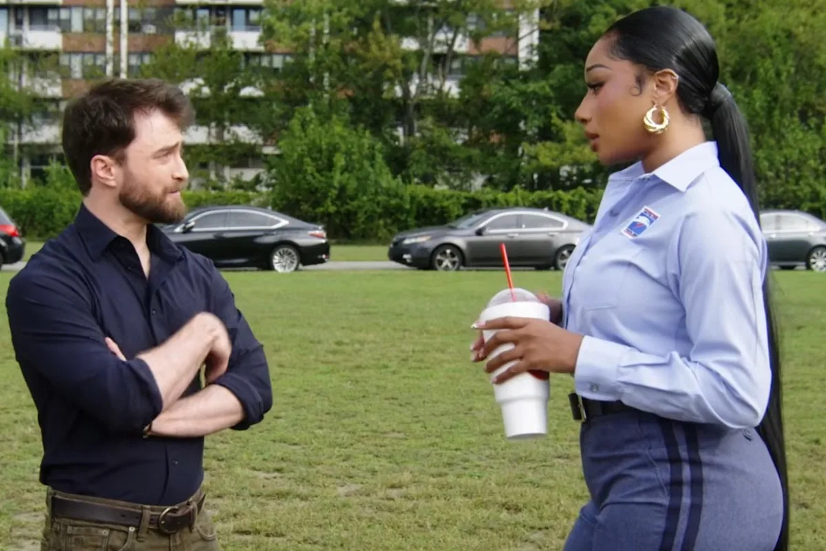 Watch Megan Thee Stallion Get Flirty With Daniel Radcliffe in ‘The Fall & Rise of Reggie Dinkins’ Scene: ‘So You Make Movies?’
