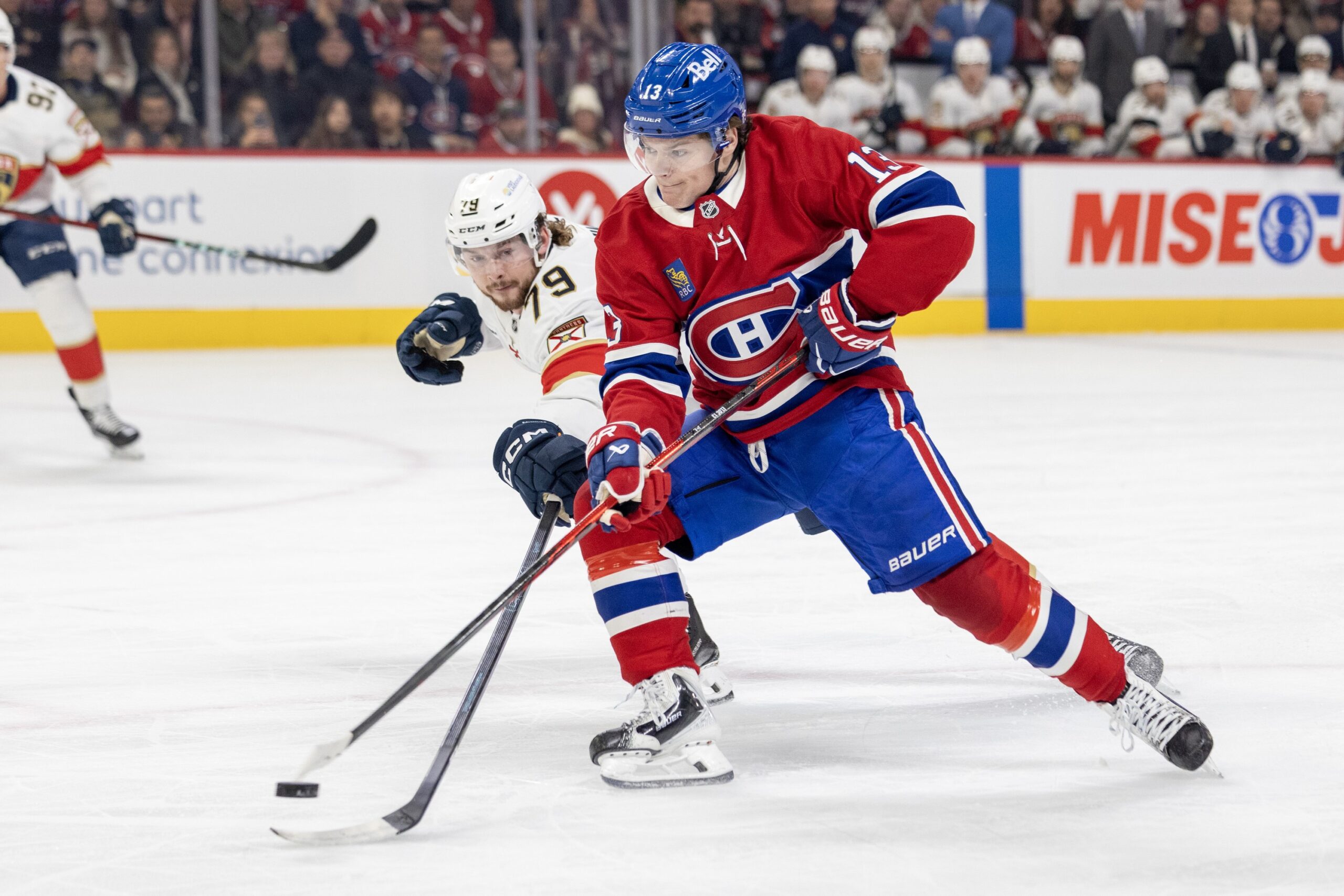 Canadiens sniper Cole Caufield unloads a backhand shot at the Florida net while being pressured by Panthers