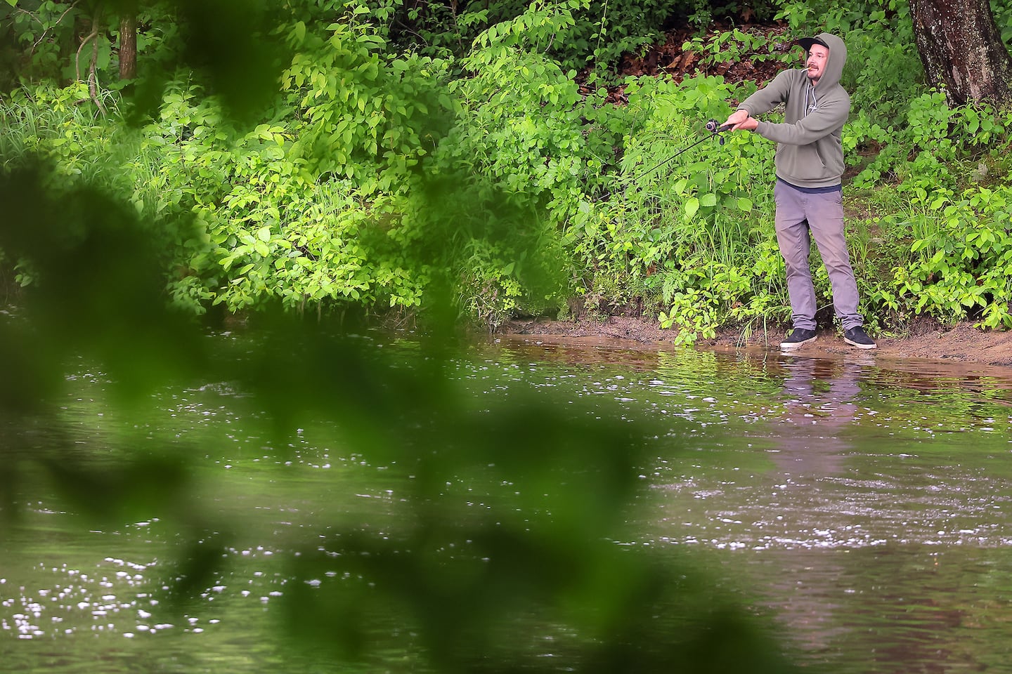 An angler casts a line into the Souhegan River opposite Emerson Park in Milford, N.H., in 2024.