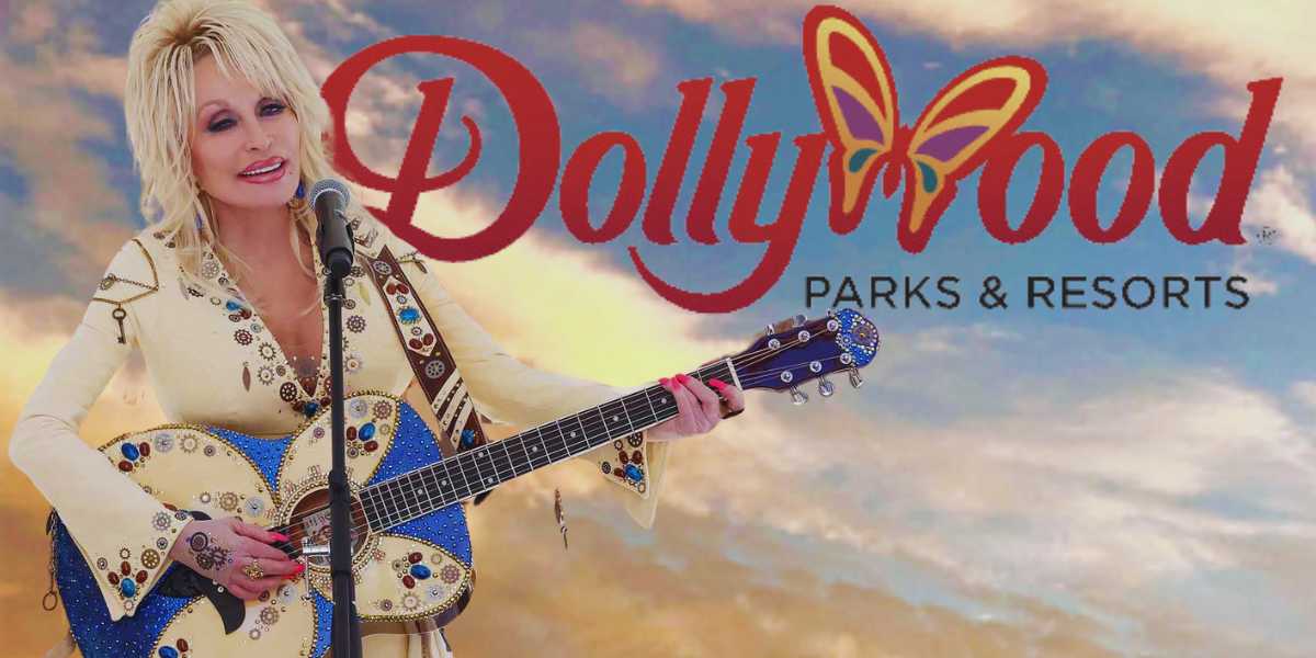 Dolly Parton holding a guitar with the 'Dollywood Parks & Resorts" logo in the background