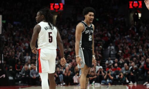 Apr 24, 2026; Portland, Oregon, USA; San Antonio Spurs guard Dylan Harper (2) reacts after scoring against Portland Trail Blazers guard Jrue Holiday (5) during the second half during game three of the first round of the 2026 NBA Playoffs at Moda Center. Mandatory Credit: Jaime Valdez-Imagn Images